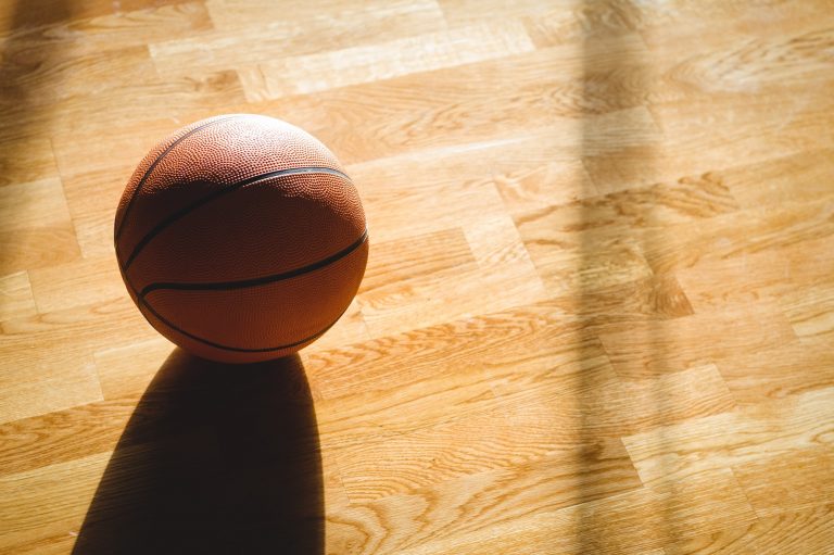 High angle view of basketball on hardwood floor